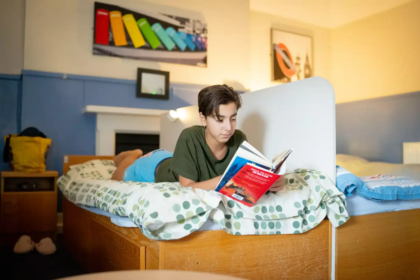 A boarder reading on his bed
